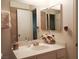 A functional vanity with a mirrored wall adds character and utility to the bathroom at 6412 Big Pine Way, Las Vegas, NV 89108