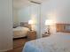 Bright bedroom with neutral decor, a wooden headboard and mirrored closet doors at 6412 Big Pine Way, Las Vegas, NV 89108