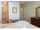 Inviting bedroom with a bench and a peek into the ensuite bathroom at 6412 Big Pine Way, Las Vegas, NV 89108