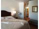 Inviting bedroom with a cozy bench, a bedside fan, and the ensuite bathroom at 6412 Big Pine Way, Las Vegas, NV 89108