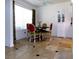 Dining room with neutral tile, dining table with chairs, and natural lighting at 6412 Big Pine Way, Las Vegas, NV 89108