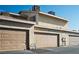 Multiple garages showcasing a well-maintained building exterior with neutral color scheme at 6412 Big Pine Way, Las Vegas, NV 89108