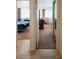A view of 2 bedrooms through doorways from a hallway with tile floors at 6412 Big Pine Way, Las Vegas, NV 89108