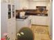 Cozy kitchen features tile flooring, black countertops, and white cabinets at 6412 Big Pine Way, Las Vegas, NV 89108