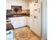 Functional kitchen featuring a refrigerator, gas range, tile backsplash, and unique tile floors at 6412 Big Pine Way, Las Vegas, NV 89108