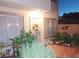 Inviting outdoor patio with secure gated entryway, lush plants, and outdoor lighting at 6412 Big Pine Way, Las Vegas, NV 89108