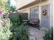 Private patio with lush greenery, seating area, and secure gated entryway, perfect for outdoor relaxation at 6412 Big Pine Way, Las Vegas, NV 89108