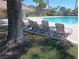 Community pool area with lounge chairs. Pool and community buildings in background at 6412 Big Pine Way, Las Vegas, NV 89108