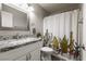 Bathroom featuring a vanity with granite countertop and a shower with cactus-themed curtain at 652 Carlos Julio Ave, North Las Vegas, NV 89031