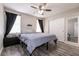 Bedroom with a queen-sized bed, ceiling fan, and mirrored closet doors at 652 Carlos Julio Ave, North Las Vegas, NV 89031