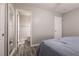 Bedroom featuring a doorway to bathroom, closet doors, and gray walls at 652 Carlos Julio Ave, North Las Vegas, NV 89031