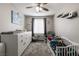 Bedroom with crib, dresser, rocking chair, and large window at 652 Carlos Julio Ave, North Las Vegas, NV 89031