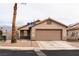 Charming single-story home featuring low maintenance desert landscaping and a two-car garage at 652 Carlos Julio Ave, North Las Vegas, NV 89031