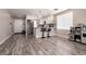 Modern kitchen with gray plank floors, white cabinetry, and a breakfast bar at 652 Carlos Julio Ave, North Las Vegas, NV 89031