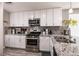 Bright kitchen features granite countertops, stainless steel appliances, and white cabinetry at 652 Carlos Julio Ave, North Las Vegas, NV 89031