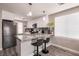 Stylish kitchen featuring a granite breakfast bar, white cabinetry, and modern appliances at 652 Carlos Julio Ave, North Las Vegas, NV 89031