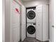 Bright laundry area features a stacked washer and dryer, concealed behind white bi-fold doors at 652 Carlos Julio Ave, North Las Vegas, NV 89031