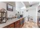 Charming kitchen featuring granite countertops, stainless steel sink and a serving hatch at 6800 E Lake Mead Blvd # 2091, Las Vegas, NV 89156