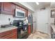 Kitchen features stainless steel appliances, granite countertops, and dark wood cabinetry at 6800 E Lake Mead Blvd # 2091, Las Vegas, NV 89156