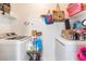 Functional laundry room with both washer and dryer, shelving and storage space at 6800 E Lake Mead Blvd # 2091, Las Vegas, NV 89156