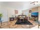 Cozy living room with tile flooring, leather sofa, plantation shutters, and a modern television at 6800 E Lake Mead Blvd # 2091, Las Vegas, NV 89156