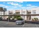Assigned covered parking spots with a modern car parked in front of updated townhome units at 6800 E Lake Mead Blvd # 2091, Las Vegas, NV 89156