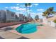 Community pool surrounded by well-maintained landscaping, palm trees, and residential buildings at 6800 E Lake Mead Blvd # 2091, Las Vegas, NV 89156