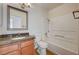 Standard bathroom featuring wood vanity, granite countertop, and shower-tub combination at 7300 Pirates Cove Rd # 2087, Las Vegas, NV 89145
