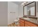 A clean bathroom featuring a granite countertop, wood cabinets, and modern fixtures at 7300 Pirates Cove Rd # 2087, Las Vegas, NV 89145