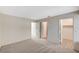 A spacious bedroom with neutral tones, carpet flooring, and multiple doorways, including a walk-in closet at 7300 Pirates Cove Rd # 2087, Las Vegas, NV 89145