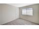 Clean, carpeted bedroom with a window and white door at 7300 Pirates Cove Rd # 2087, Las Vegas, NV 89145