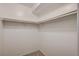 A simple walk-in closet with built-in rods and shelving, perfect for organized storage solutions at 7300 Pirates Cove Rd # 2087, Las Vegas, NV 89145