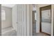 Hallway with bedroom on left and stacked washer and dryer in small utility room on right at 7300 Pirates Cove Rd # 2087, Las Vegas, NV 89145