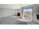 Spacious living room with fireplace and sliding glass door access to a balcony at 7300 Pirates Cove Rd # 2087, Las Vegas, NV 89145