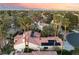 Aerial view showcases tile roof, solar panels, mature trees, lush landscaping, and sparkling pool at 7608 Painted Dunes Dr, Las Vegas, NV 89149