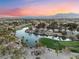 Panoramic aerial view of a serene lake in a golf course community with a backdrop of stunning mountain views at 7608 Painted Dunes Dr, Las Vegas, NV 89149
