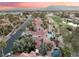 Breathtaking aerial view of houses in a community, showcasing lush green golf course and mature landscaping at 7608 Painted Dunes Dr, Las Vegas, NV 89149