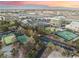 Beautiful aerial view of tennis courts, commercial areas, and desert landscaping, against a mountain backdrop at 7608 Painted Dunes Dr, Las Vegas, NV 89149