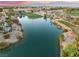 Aerial view of a serene golf course and a calm lake, surrounded by lush trees and vegetation at 7608 Painted Dunes Dr, Las Vegas, NV 89149