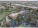 Aerial view showcasing the community clubhouse, golf course, and tennis courts in a well-planned neighborhood at 7608 Painted Dunes Dr, Las Vegas, NV 89149