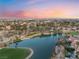Aerial view featuring a serene lake in a golf course community, complemented by mature landscaping at 7608 Painted Dunes Dr, Las Vegas, NV 89149