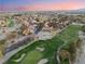 Scenic aerial view of homes bordering a lush green golf course with mature landscaping and trees at 7608 Painted Dunes Dr, Las Vegas, NV 89149