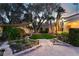A tranquil backyard featuring a koi pond, mature landscaping and a paved pathway at 7608 Painted Dunes Dr, Las Vegas, NV 89149