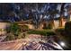 Serene backyard garden featuring lush landscaping, a pond with fountain and stone walkway, perfect for relaxation at 7608 Painted Dunes Dr, Las Vegas, NV 89149