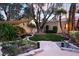 A tranquil backyard featuring a koi pond, mature landscaping and stone pathway at 7608 Painted Dunes Dr, Las Vegas, NV 89149