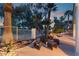 Backyard patio with comfortable seating arrangement next to a fire pit overlooking the pool and palm trees at 7608 Painted Dunes Dr, Las Vegas, NV 89149