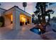 A covered patio and spa provide a serene outdoor living space with lush landscaping and mature palm trees at 7608 Painted Dunes Dr, Las Vegas, NV 89149