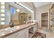 Luxurious bathroom featuring a double vanity, elegant lighting, and a separate shower, providing a spa-like experience at 7608 Painted Dunes Dr, Las Vegas, NV 89149
