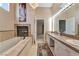 Luxurious bathroom features a soaking tub, fireplace and double sink vanity at 7608 Painted Dunes Dr, Las Vegas, NV 89149