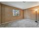 Bedroom with a textured wall, large window, and neutral carpeting at 7608 Painted Dunes Dr, Las Vegas, NV 89149
